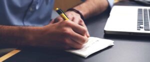 man writes down bar study loan options on napkin