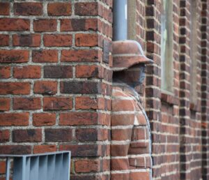 man hidden in bricks
