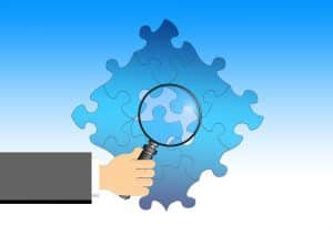 magnifying glass looking at the parts representing an income share agreement