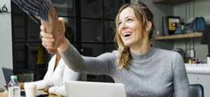 student loan borrower shakes hand after reaching a deal with lender