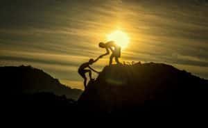parent helping a child up a hill